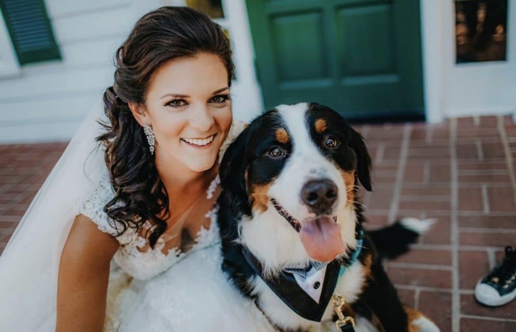 Furry-Ventures-Pet-Care-Bride posing with her dog in a bow tie