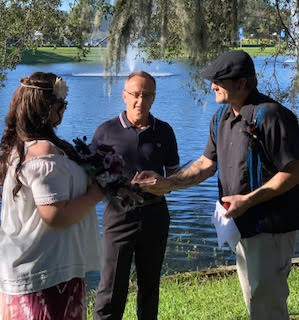 bride and groom with officiant at casual outdoor wedding by lake - classically cool event productions florida