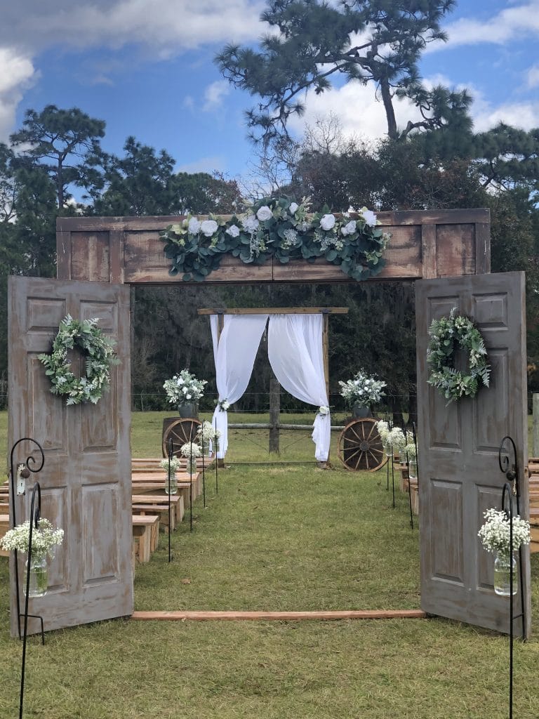 Diamond L Venue - rustic doors opening up to aisle for wedding ceremony