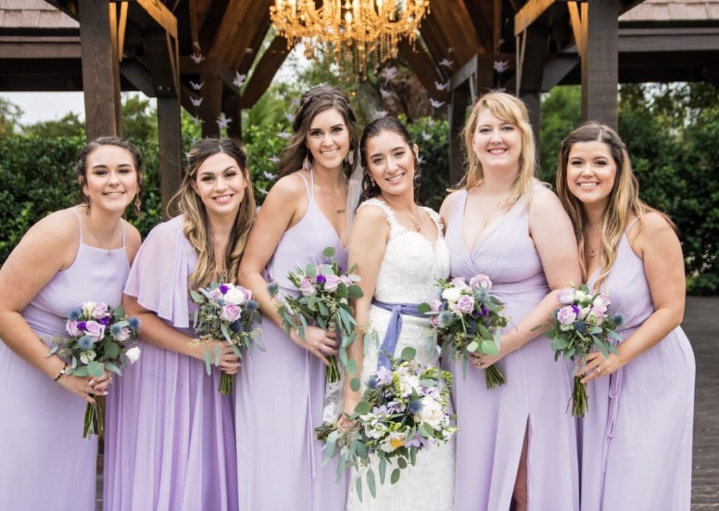 Honeywood Photography photo of bride with bridesmaids in lavender dresses and colorful bouquets