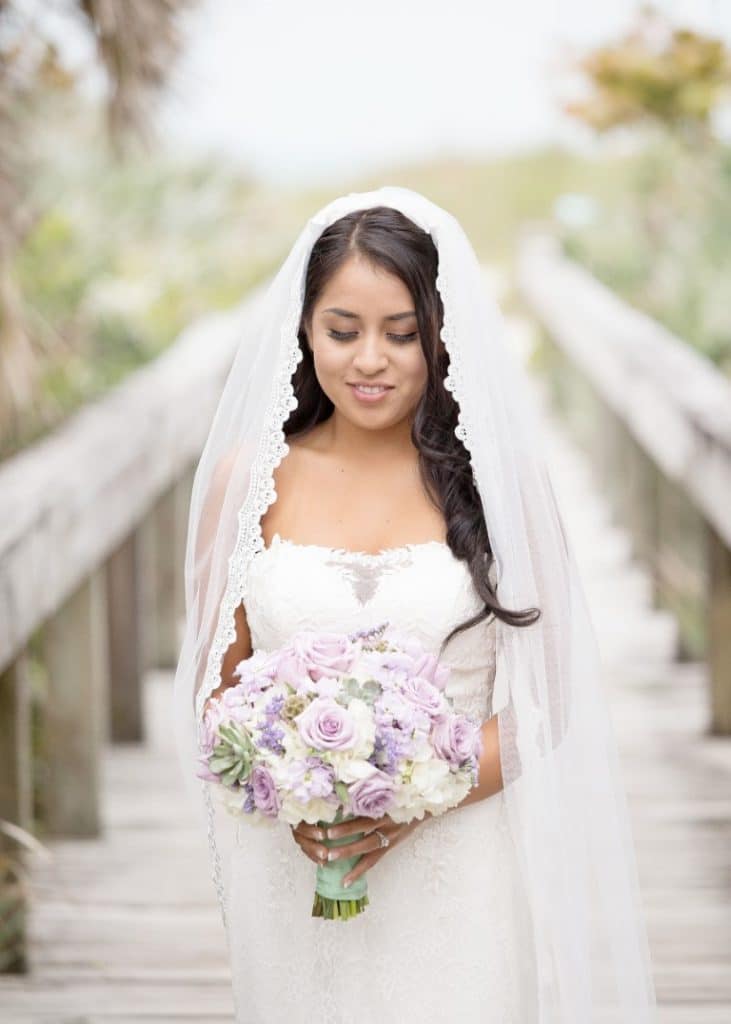 Honeywood Photography photo of bride on a wooden walkway out to the bech