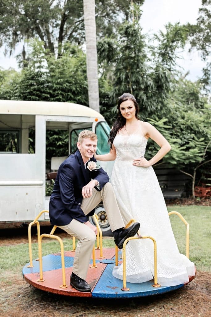 Honeywood Photography photo of a bride and groom standing on a vintage merry go round