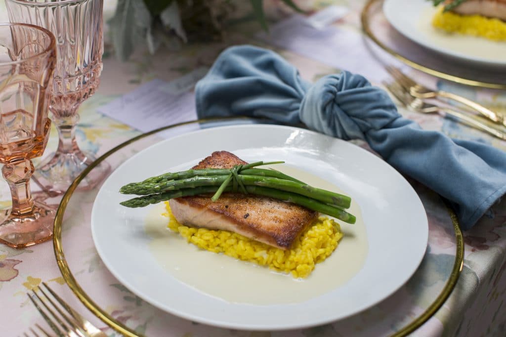 fish dinner served at a table set for a wedding reception