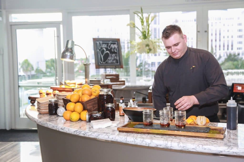 Arthur's Creative Events and Catering - man serving drinks behind a bar