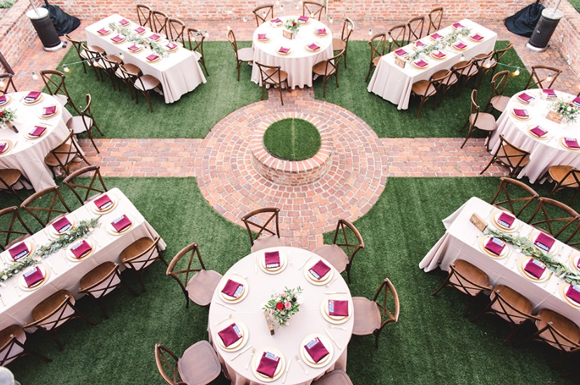 Arthur's Creative Events and Catering - tables prepared in a grassy courtyard