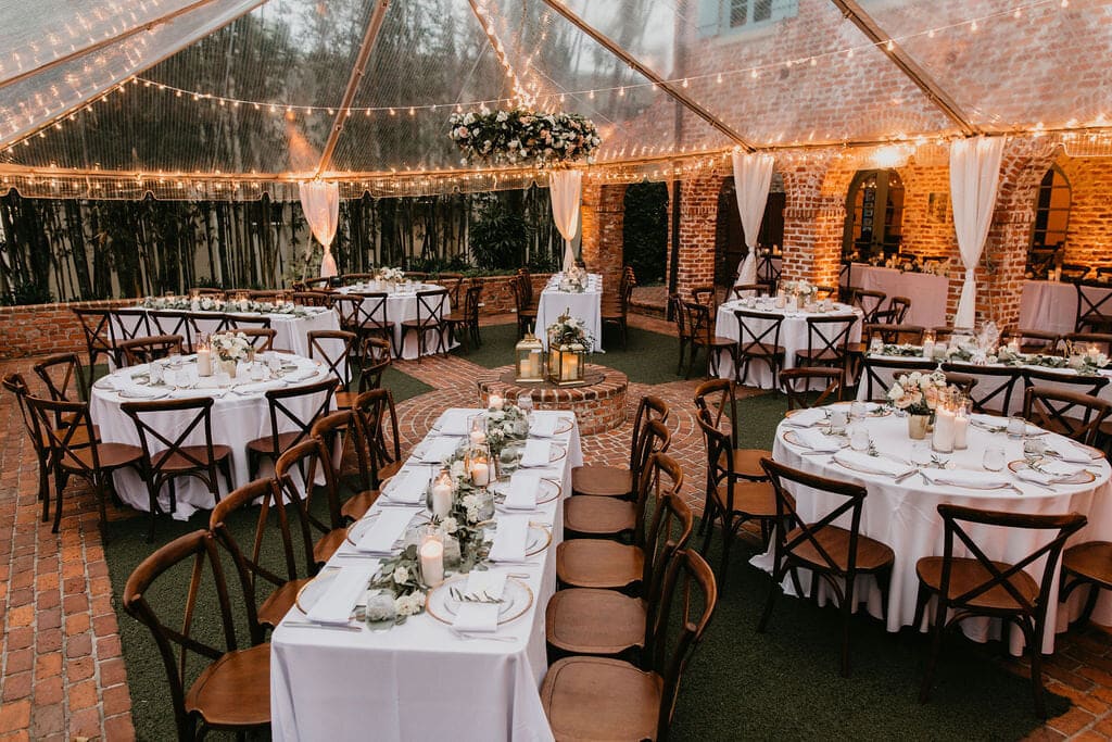 Arthur's Creative Events and Catering - tables prepared under a canopy of string lights