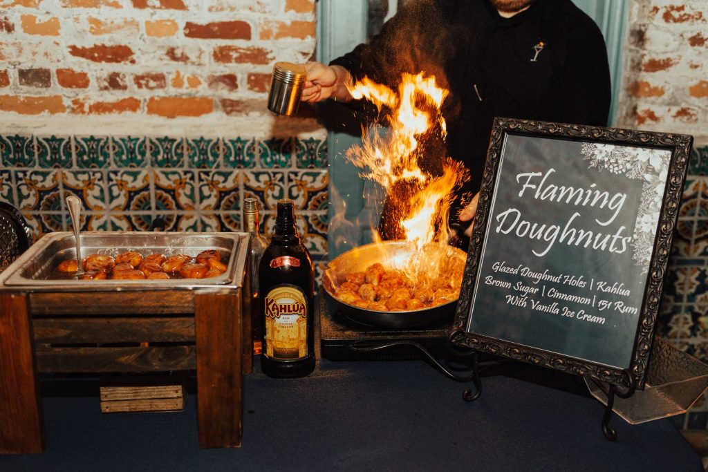 Arthur's Creative Events and Catering - chef preparing flaming doughnuts over a flame