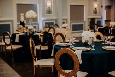 Barney E. Veal Center wedding reception tables with black tablecloth and white flowers