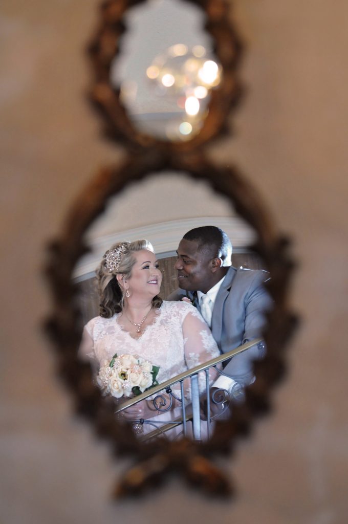 Jennifer Juniper Photography - Mirror reflecting bride and groom holding each other