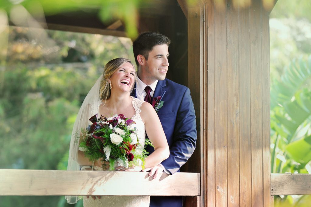 Jennifer Juniper Photography - Bride and groom laughing on a bridge