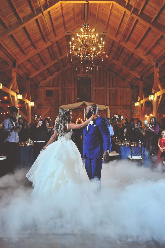 Jennifer Juniper Photography - Bride and groom dancing in barn with fog on dance floor