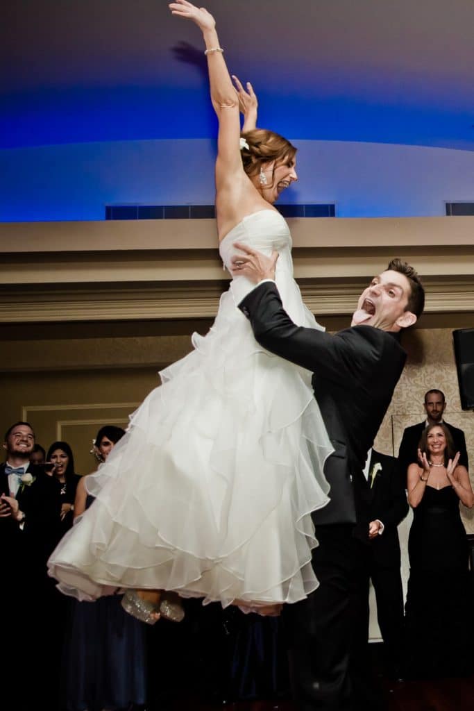 Groom holding up bride in dance pose