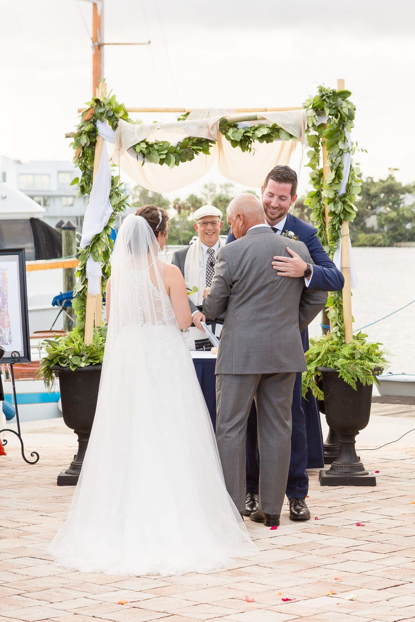 things go wrong at a wedding - father of the bride hugging groom at alter