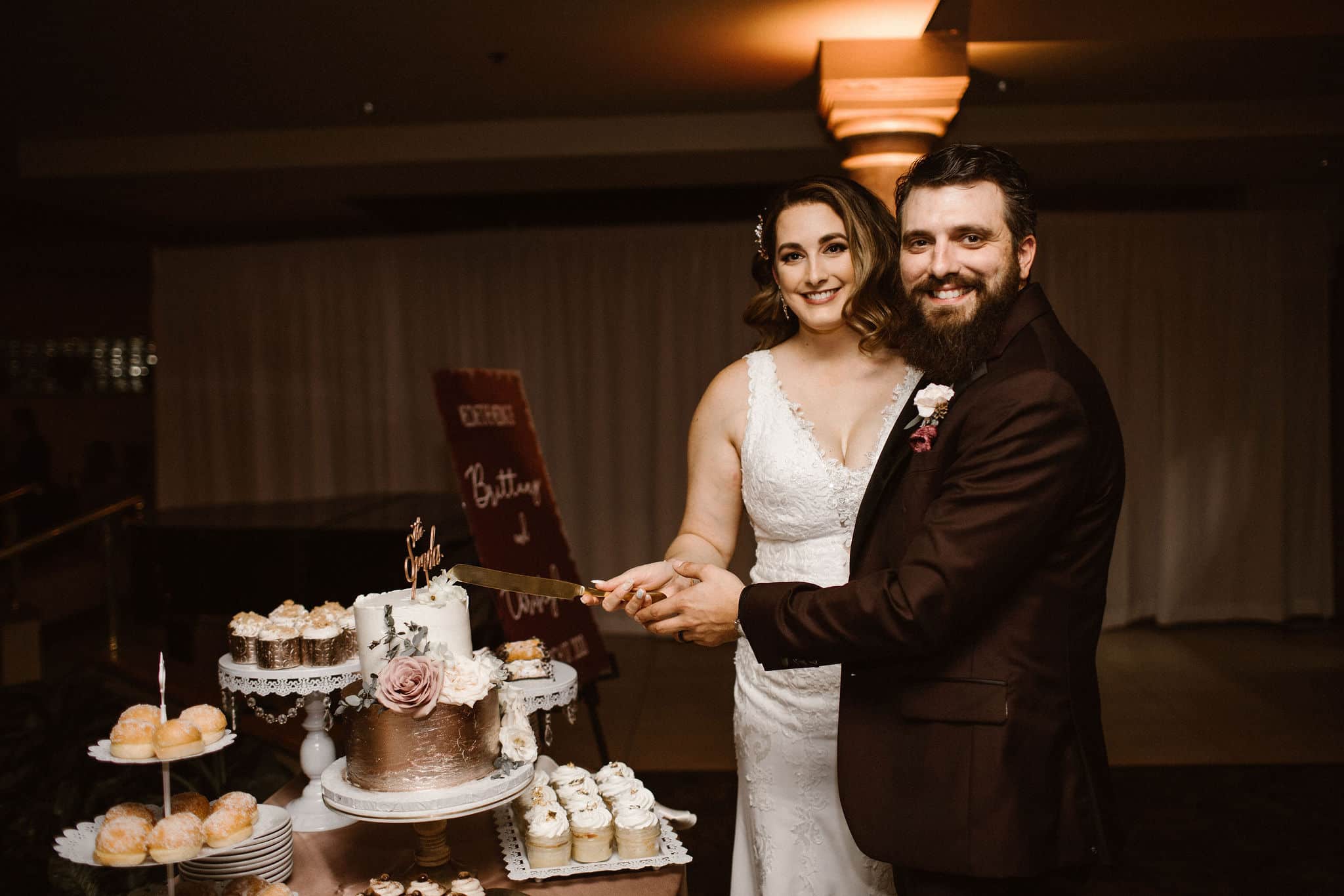 Bride and groom cutting cake at a Spanish style wedding venue in Florida