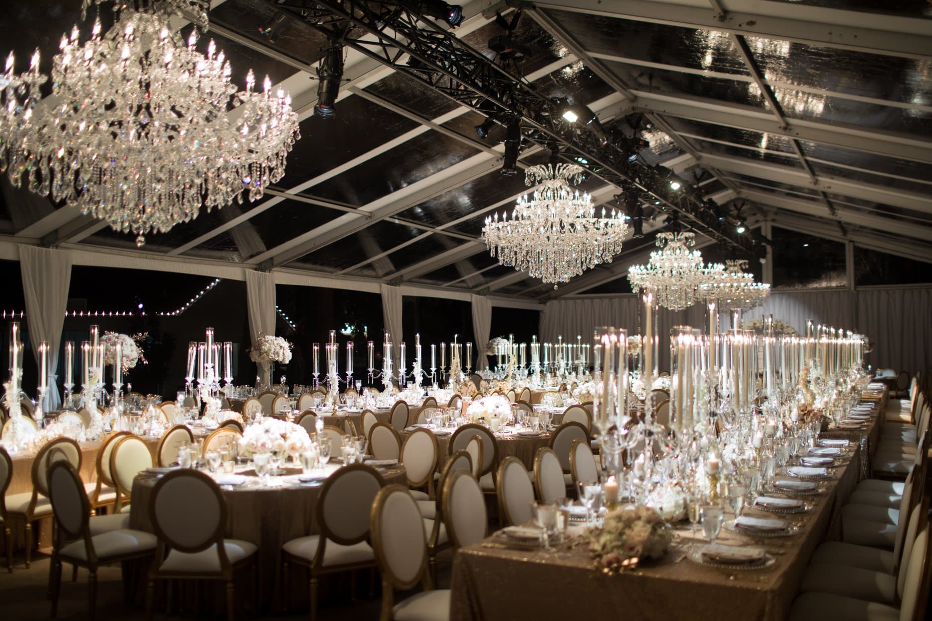 reception set up with tables and chandeliers