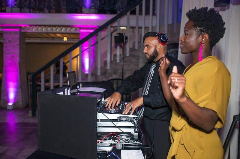 Complete Weddings + Events DJs partying with uplights in background
