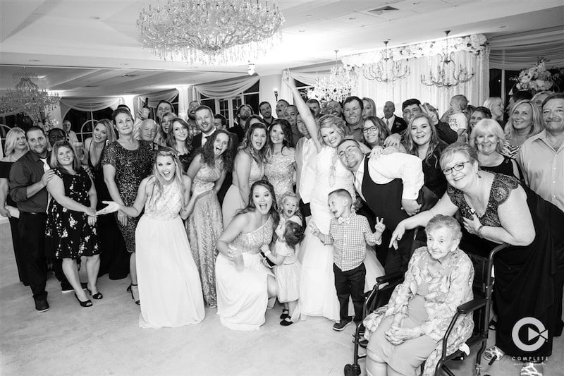 Complete Weddings + Events wedding guests posing for group picture in black and white