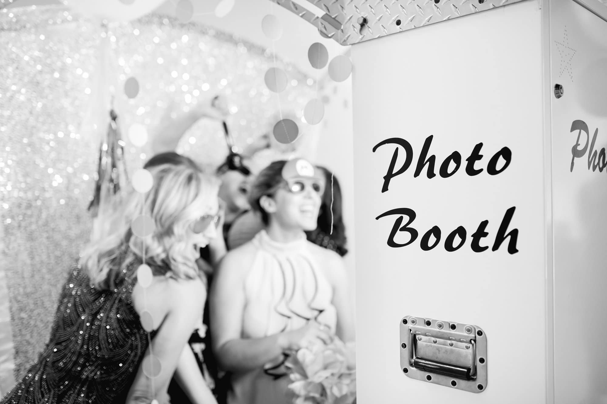black and white photo of guests in photobooth