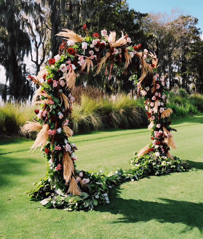 Lowe and Behold flower archway used for outdor wedding ceremony