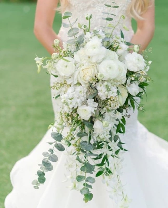 Lowe and Behold bride holding large white flower bouquet