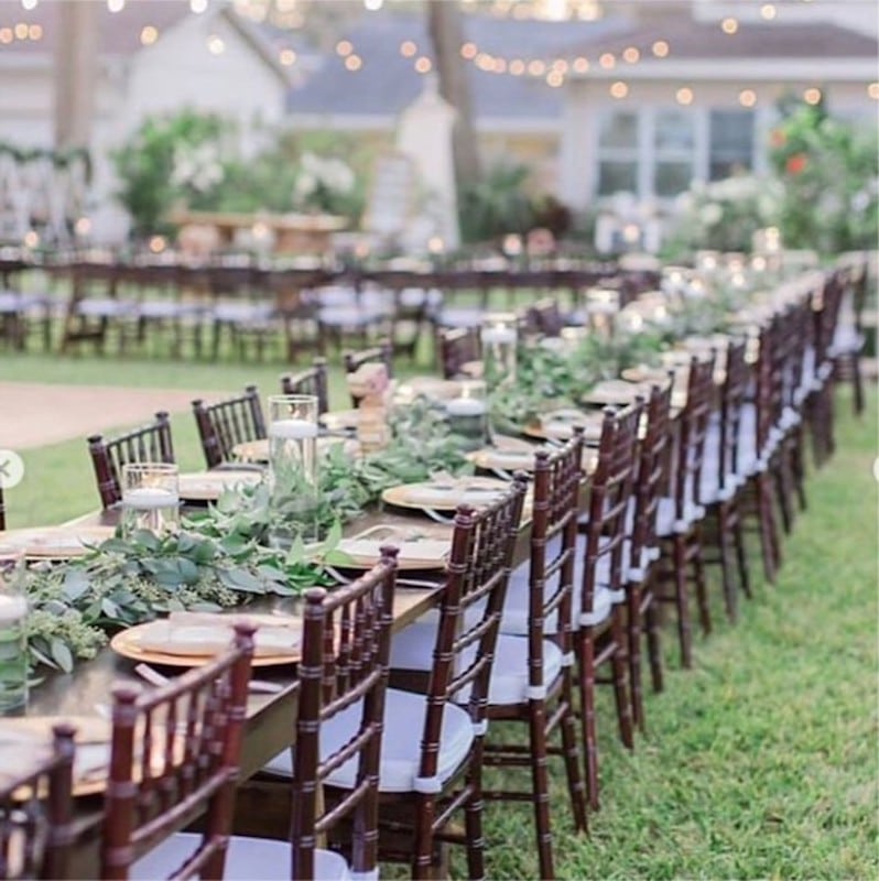 Lowe and Behold outdoor wedding reception with long tables setup for guests and beautiful flower center arrangements