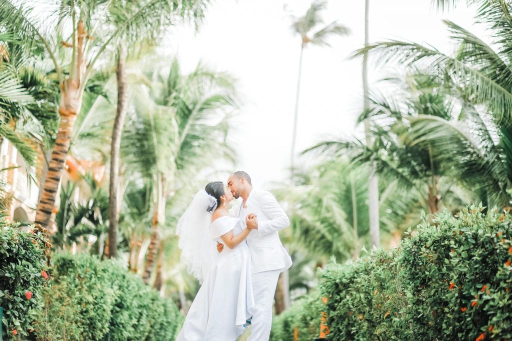 Marriage License by Mail, bride & groom kissing under palms