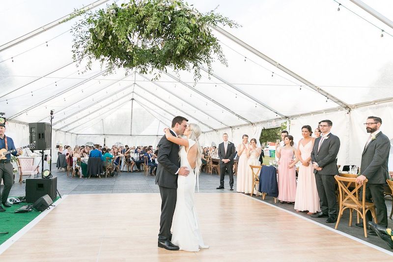 Just Marry bride and groom first dance with bridal party and guests watching