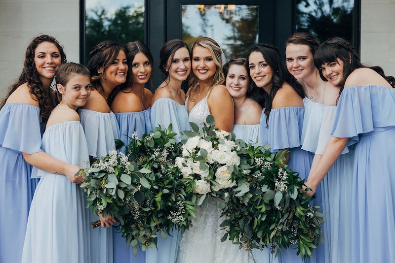 Just Marry bride and her bridesmaids in matching blue dresses