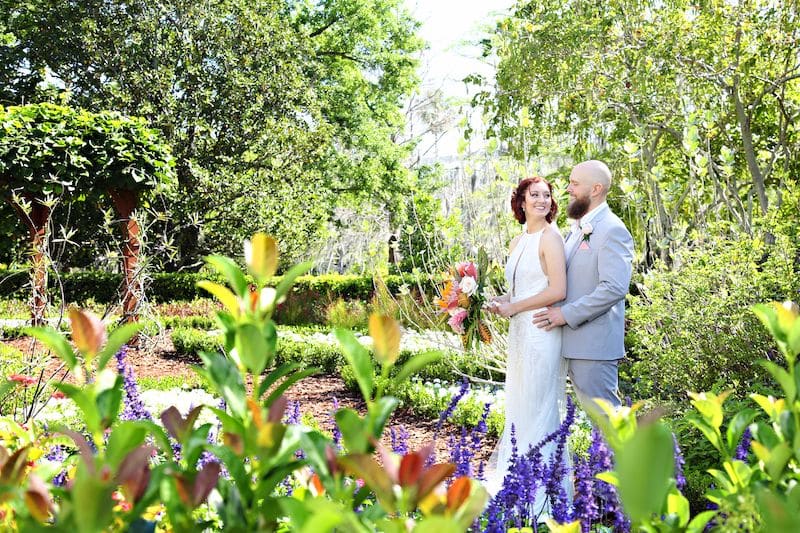 Just Marry bride and groom standing in garden