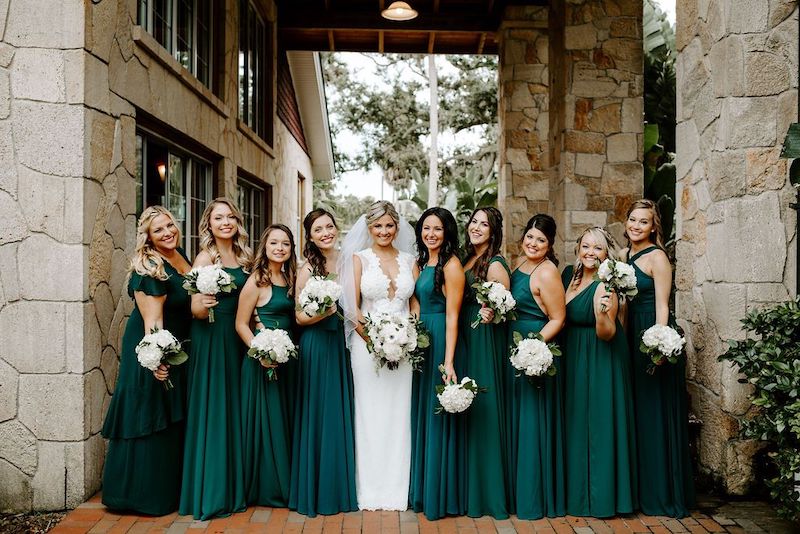 Just Marry! bride standing with her bridesmaids surrounding her