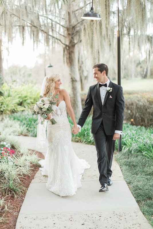 Just Marry! bride and groom walking through garden holding hands