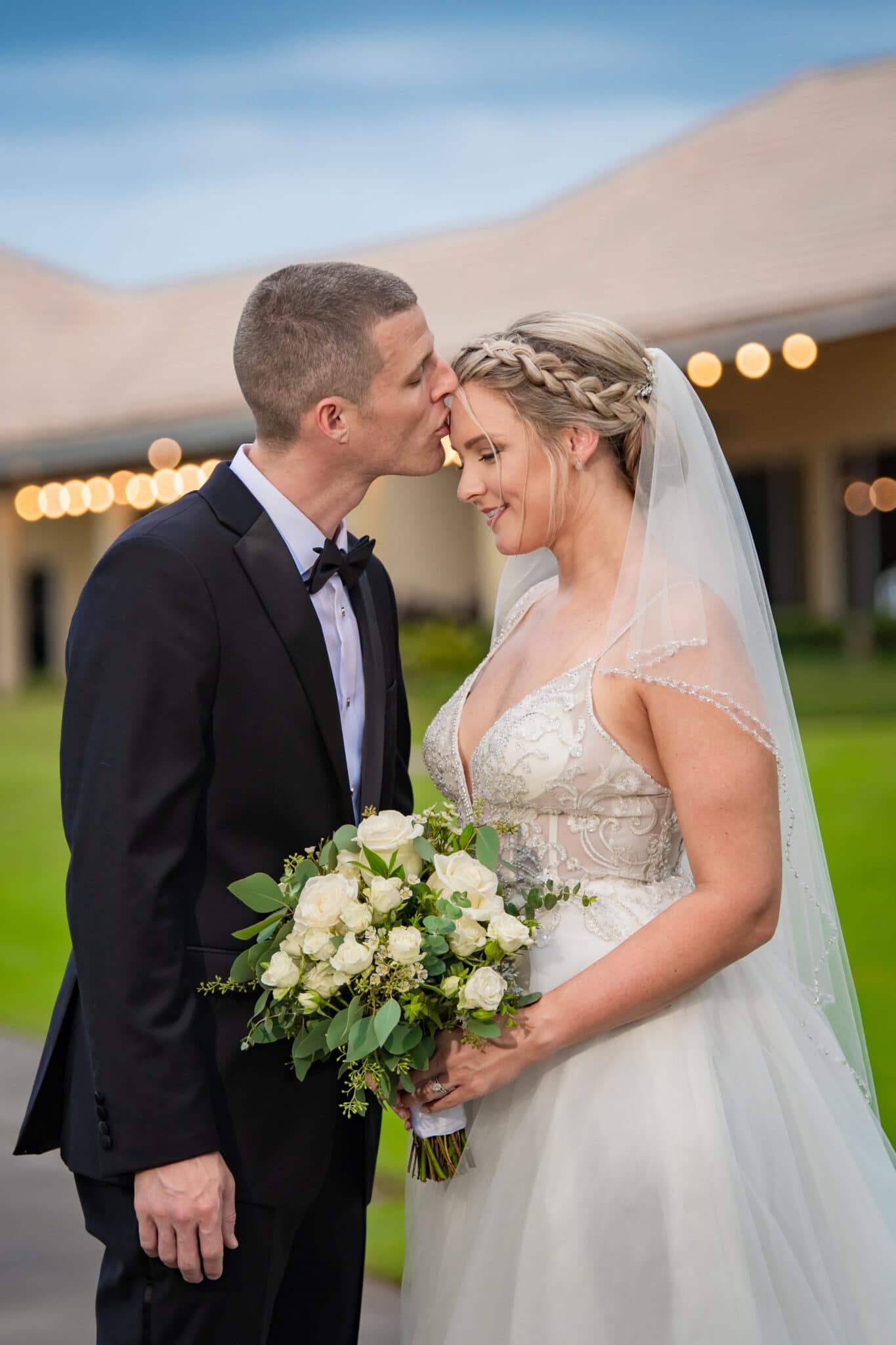 Bride and groom kissing at LPGA country club using natural lighting
