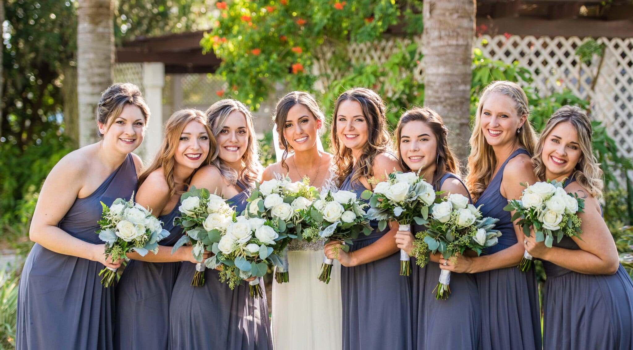 bride and her bridesmaids in matching dresses and matching bouquets