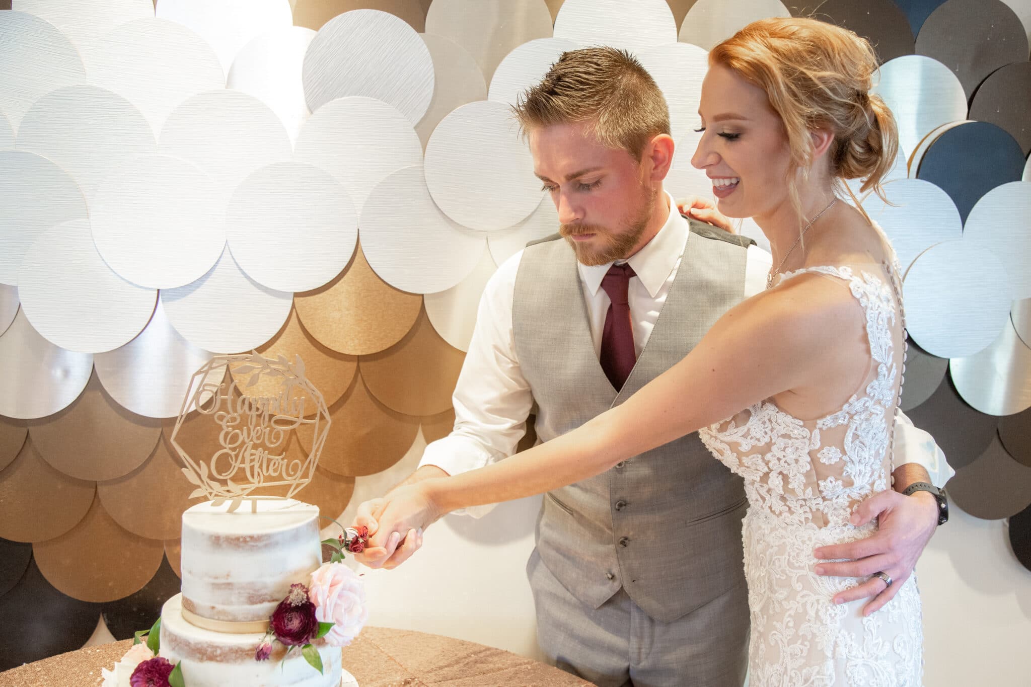 bride and groom cutting their Paddlefish at Disney Springs wedding cake