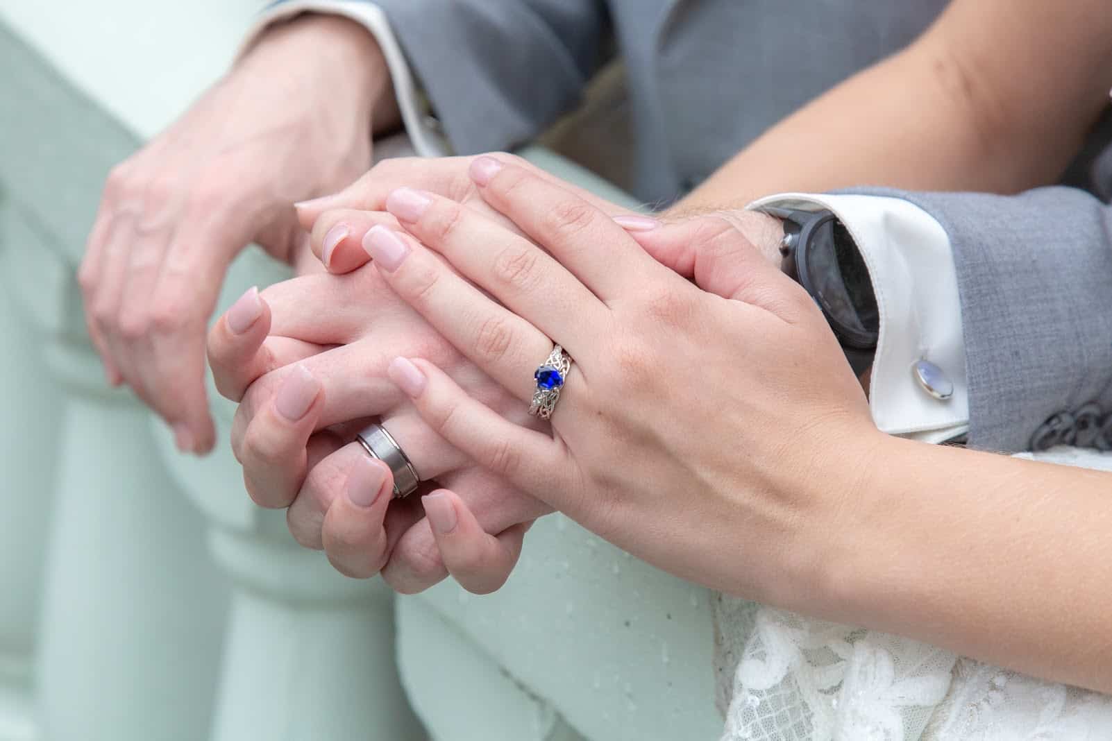 bride and groom hands with their wedding rings