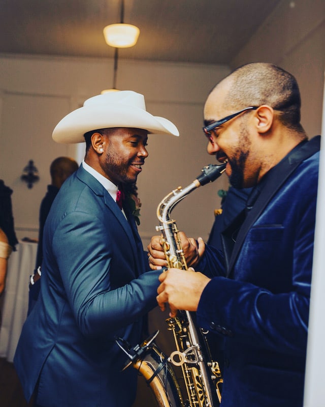 RLE3 Music saxophone player performing and congratulating groom who is wearing a white cowboy hat