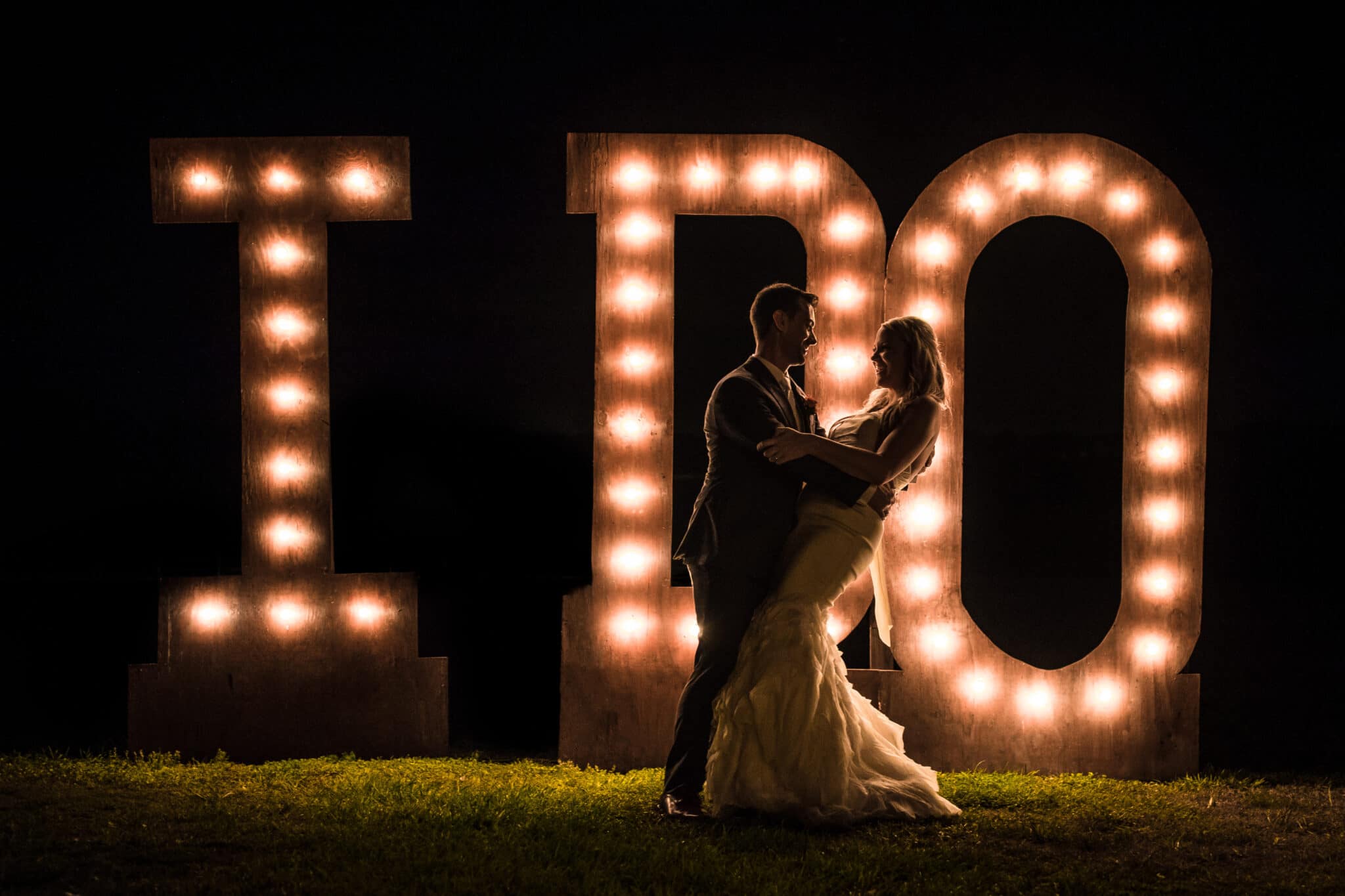 bride & groom in front of I DO lights