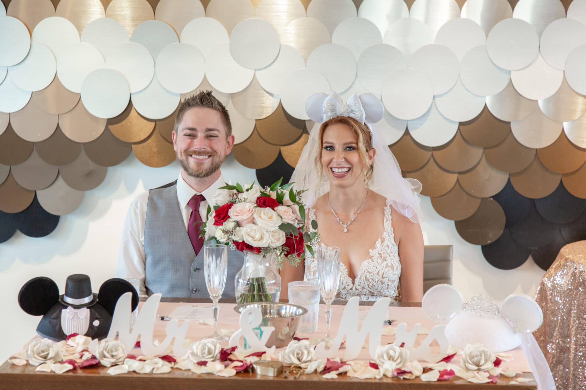 Bride and groom sitting at a sweetheart table during their Paddlefish at Disney Springs wedding reception