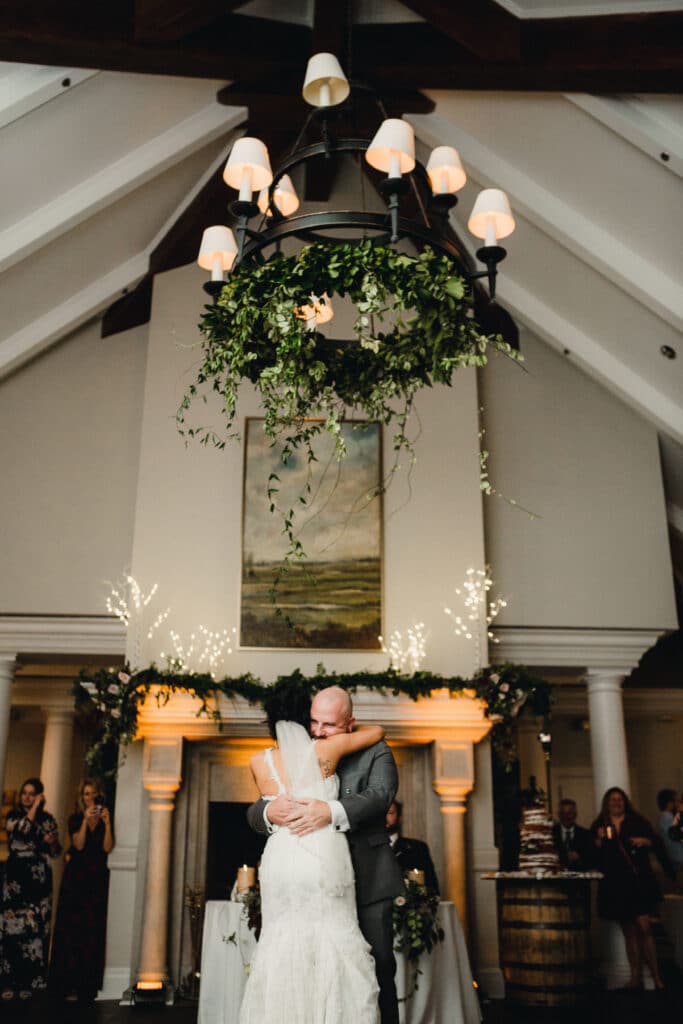 bride hugging her father after father daughter dance