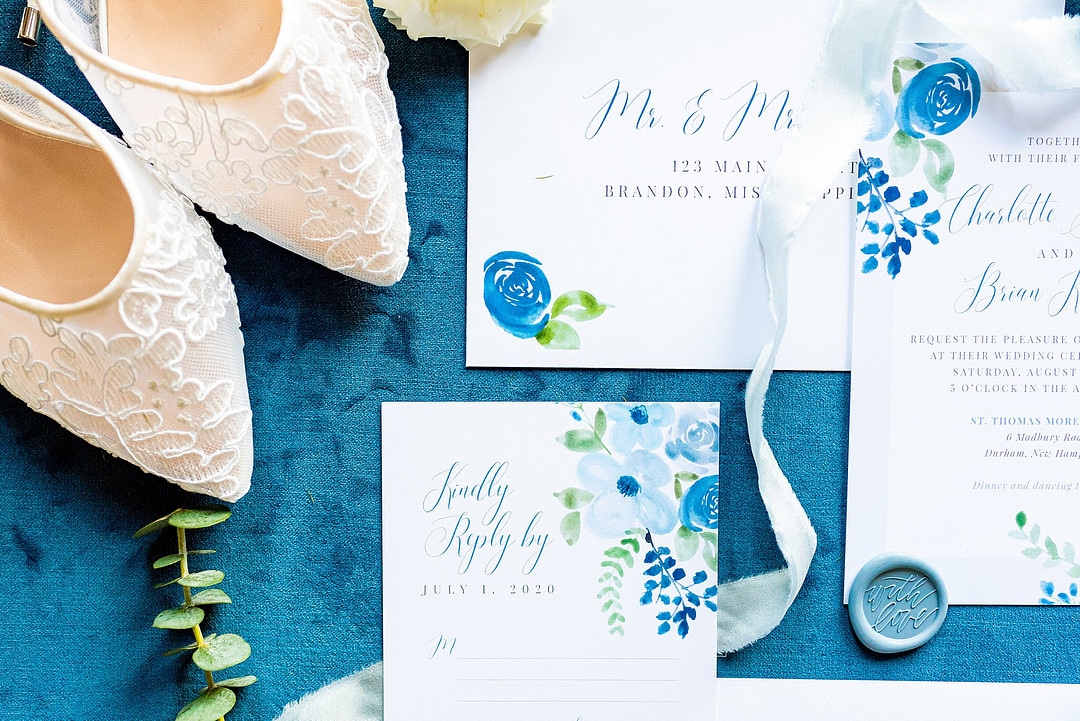 dusty pastel wedding inspiration flat lay design with lace heels and ribbon and calligraphy pieces