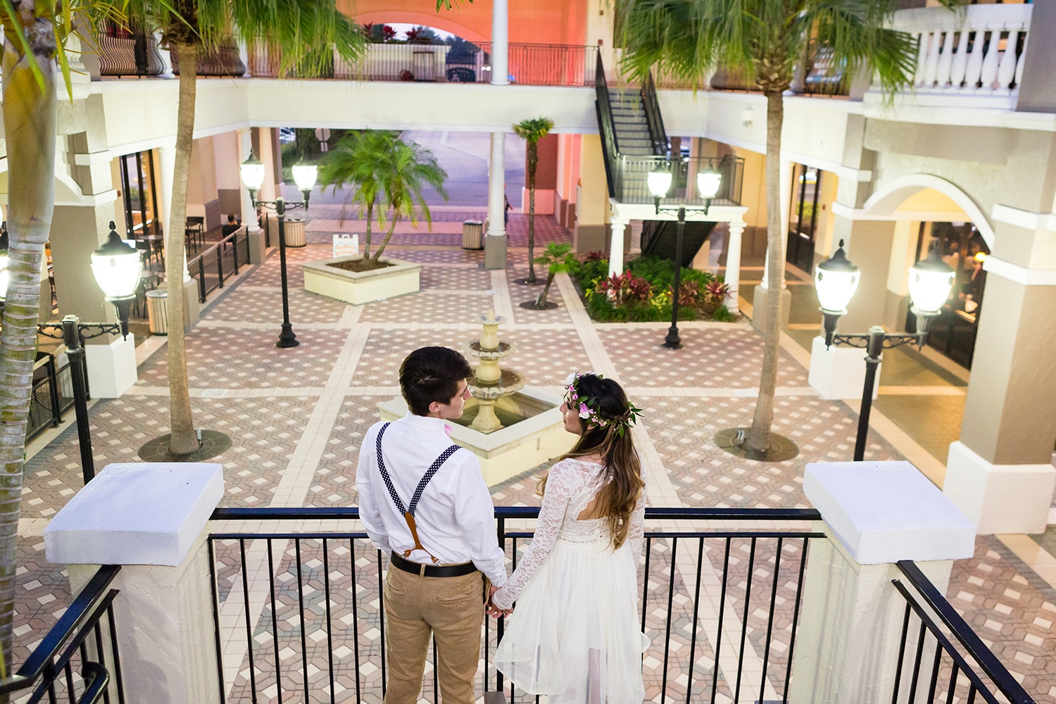 bride & groom on balcony looking out over venue