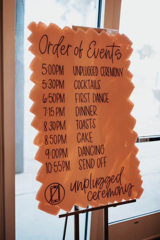 sign on easel listing wedding and reception timeline for event at brannon center florida