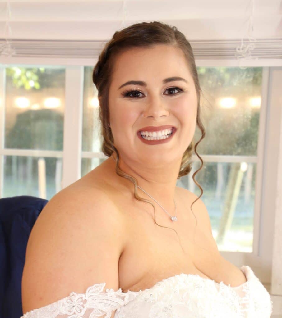 bride smiling while in wedding dress with professional hair and makeup from House of Sheen Glam Team