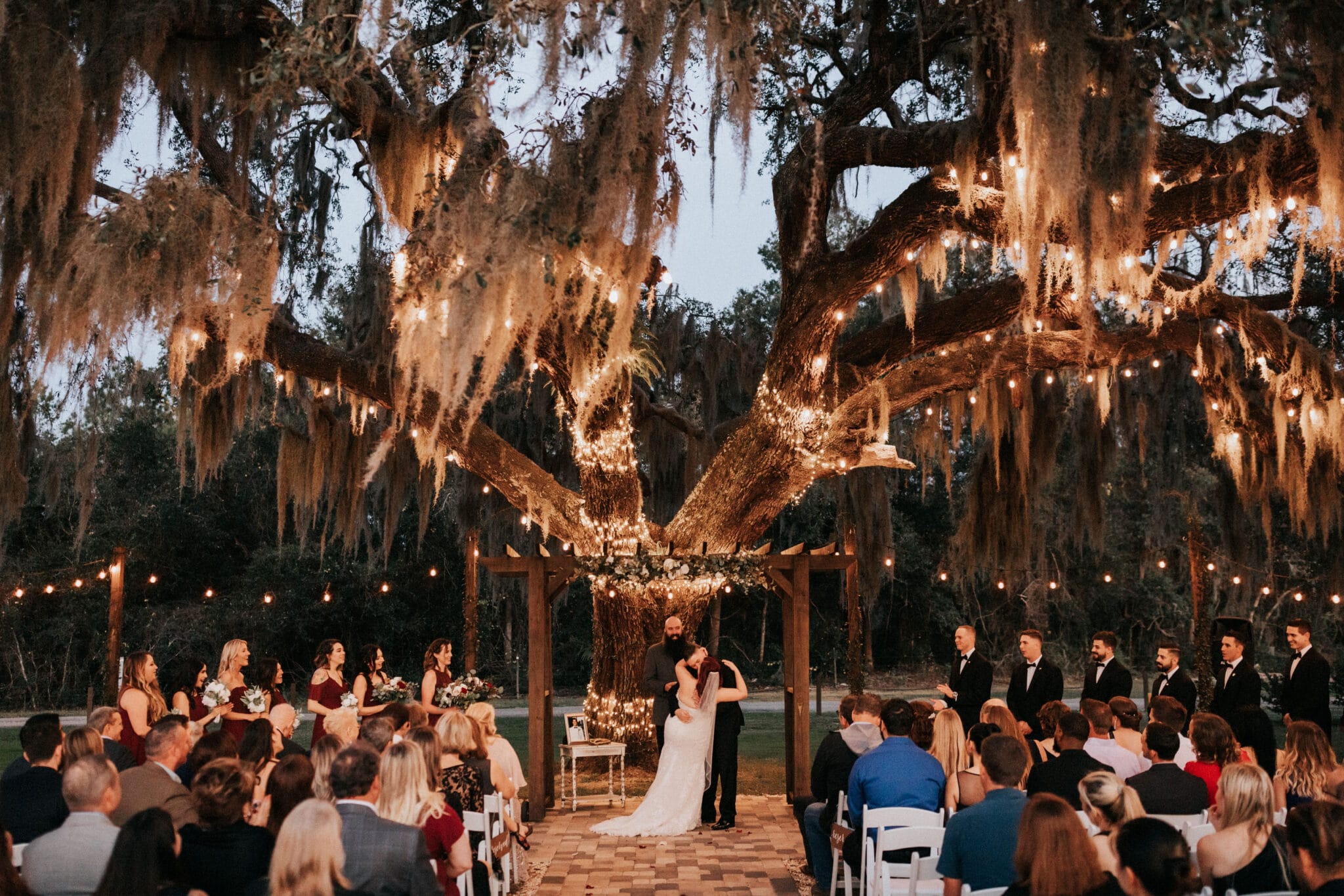 ceremony under trees with lights