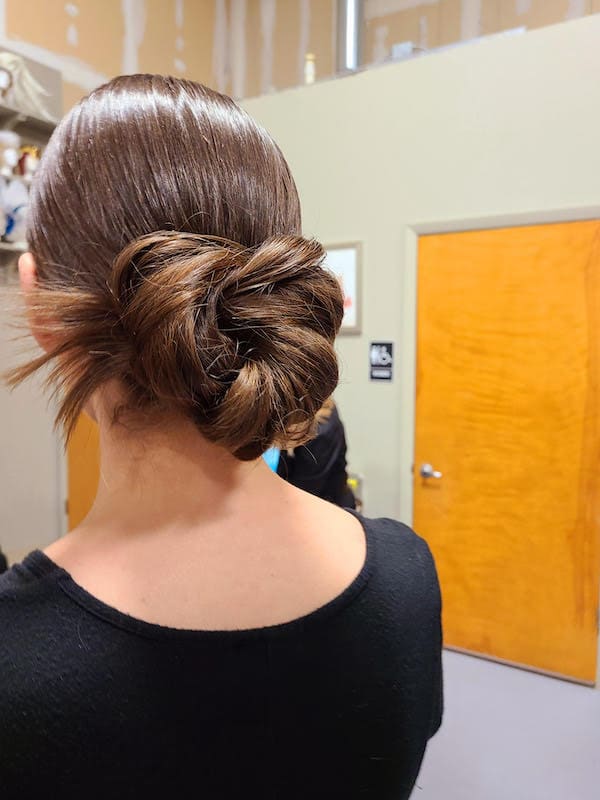 woman's hair professionally styled in a bun by House of Sheen Glam Team