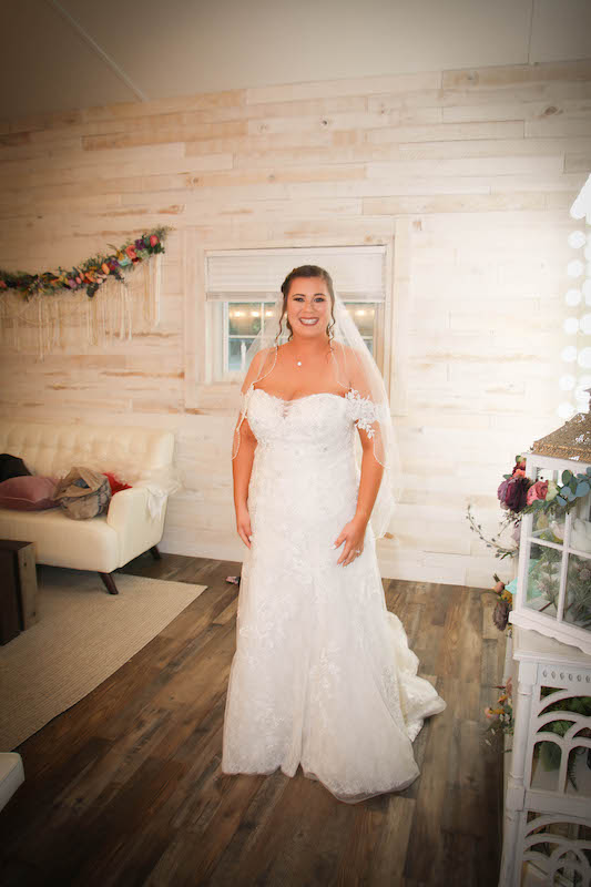 bride smiling in her wedding dress with full hair and makeup done by House of Sheen Glam Team