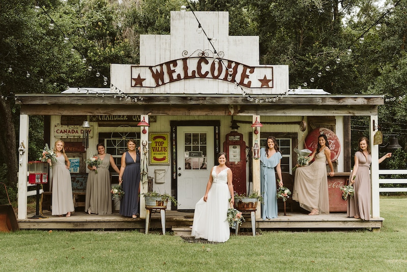 bride and her bridesmaids standing in front of old country store