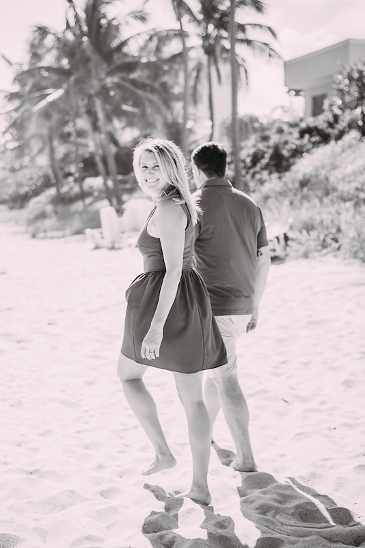 couple walking barefoot on the beach