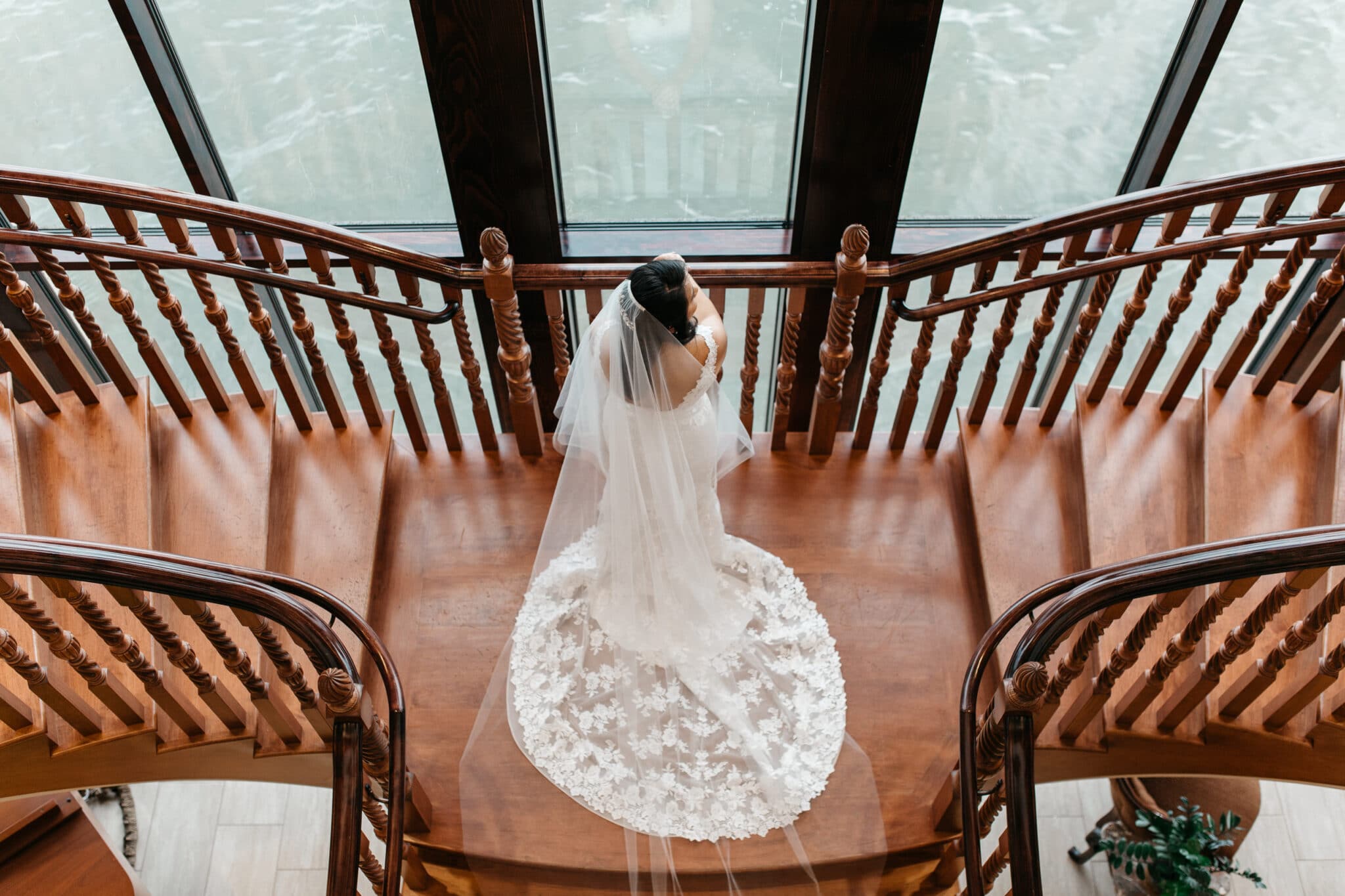 looking down over bride on staircase with train displayed