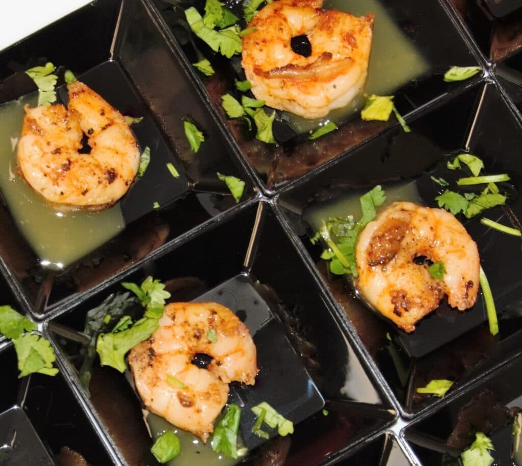 individual shrimp appetizers ready to be served at wedding reception
